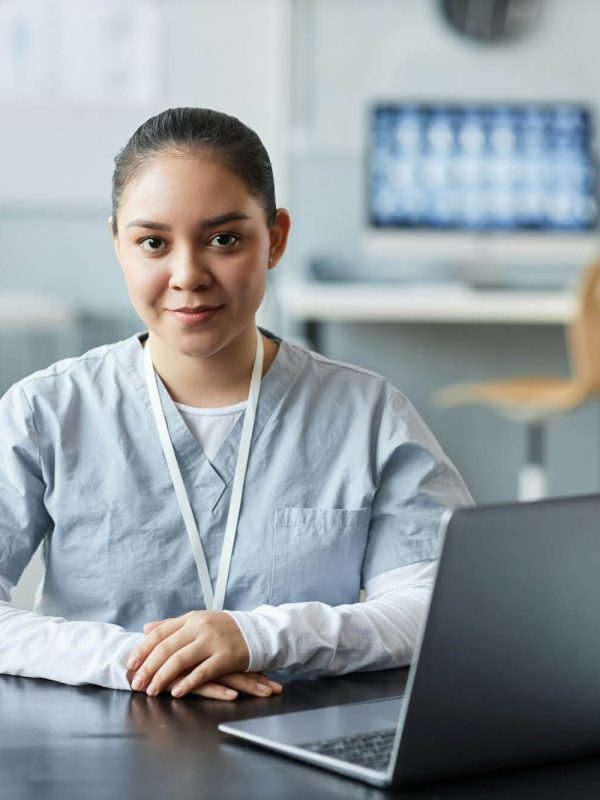 young-pretty-female-doctor-or-assistant-looking-at-camera-by-workplace.jpg